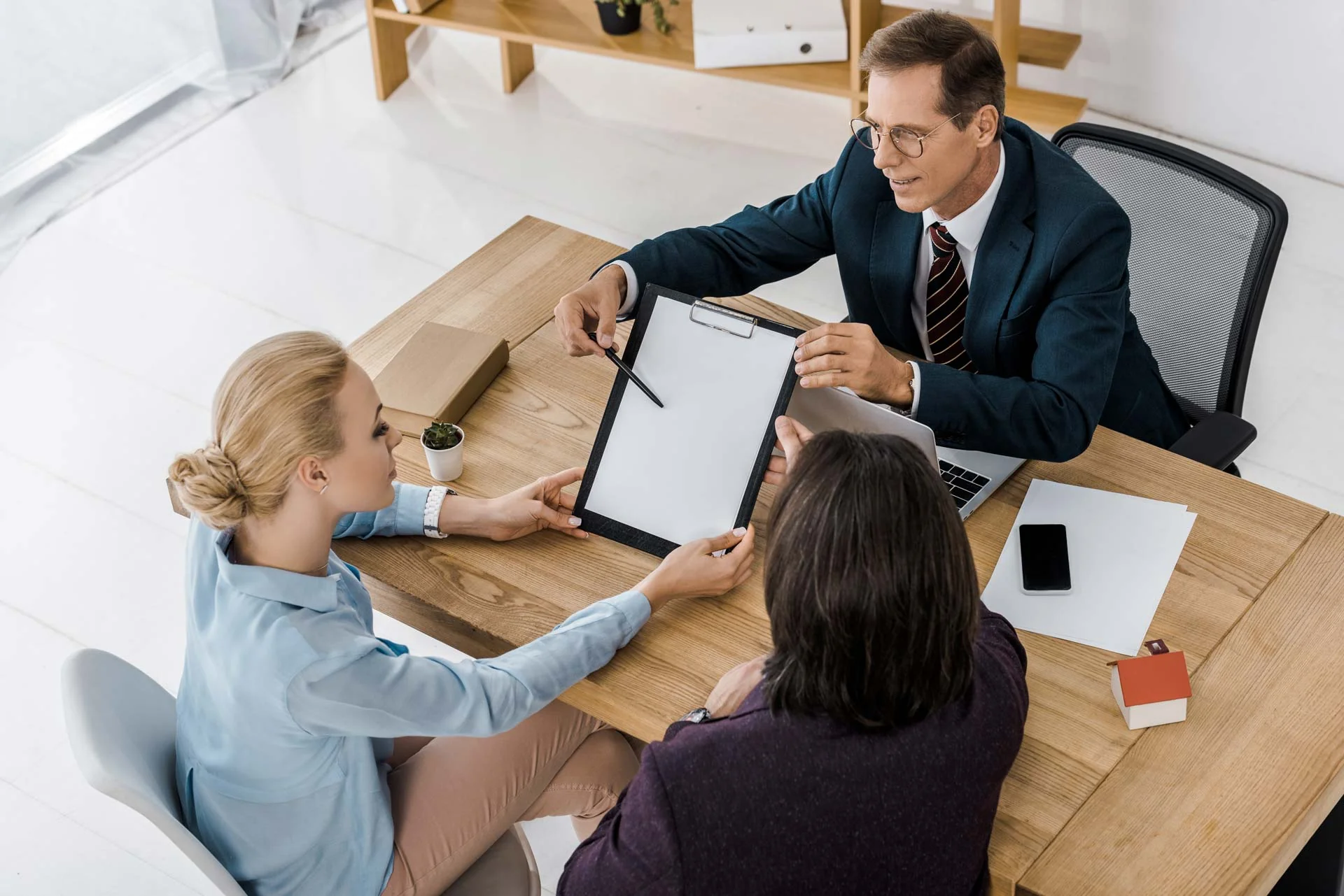 adult insurance agent showing contract
