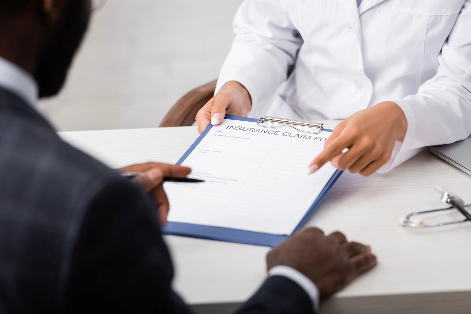 doctor pointing with finger at insurance