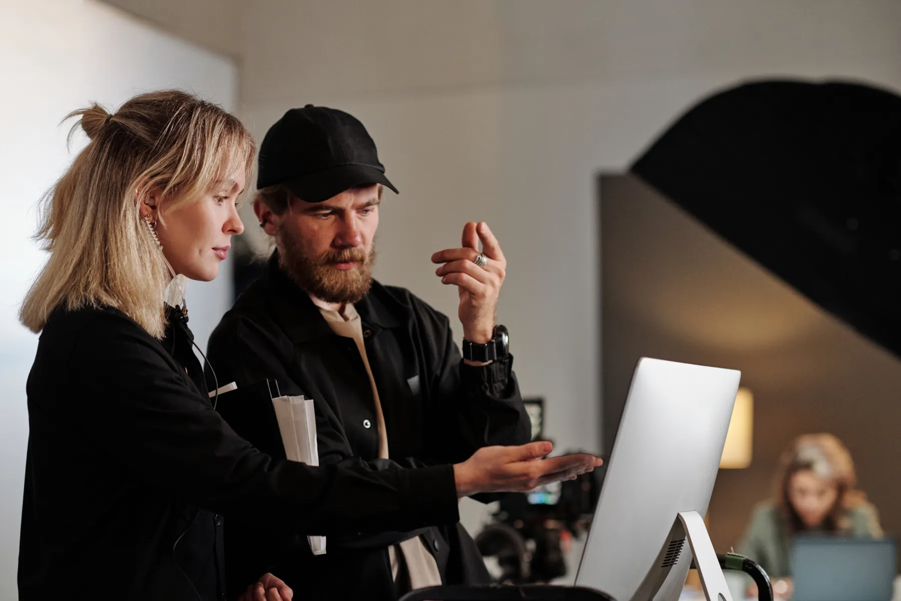 young female assistant of videographer pointing