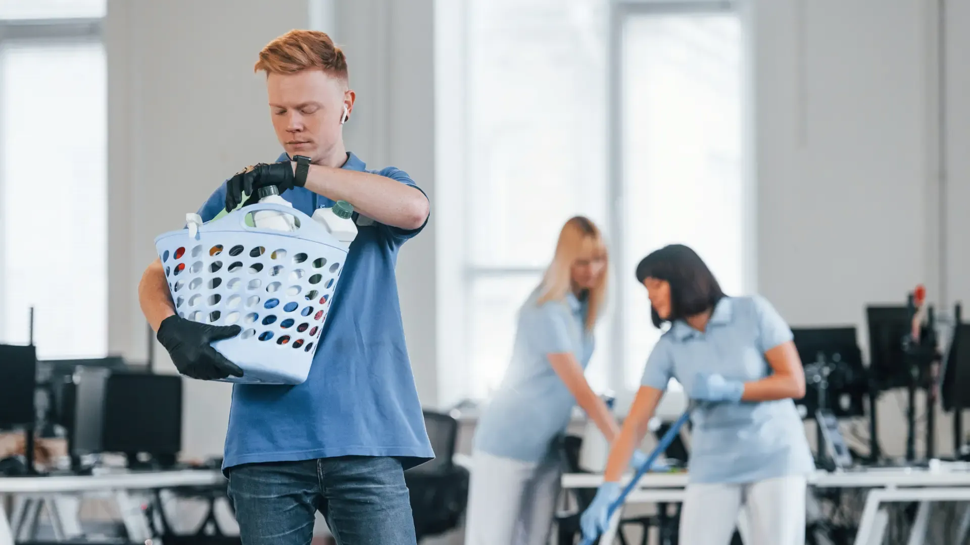 woman-uses-vacuum-cleaner-group-of-workers-clean