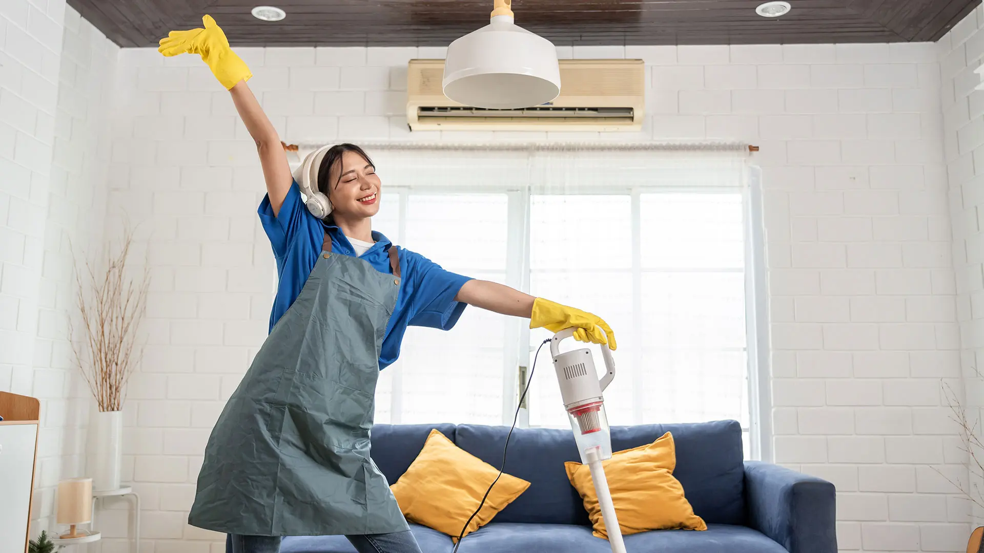 asian-young-woman-cleaner-dancing-while-cleaning